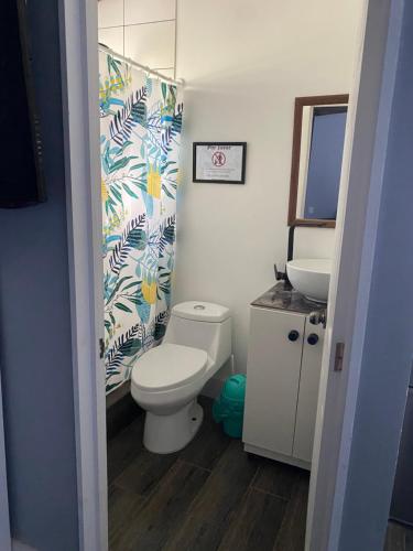 a bathroom with a toilet and a sink at Cabaña bosquepaz in Algarrobo