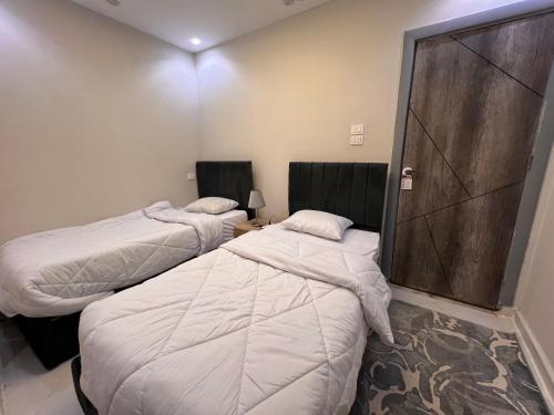 Ένα ή περισσότερα κρεβάτια σε δωμάτιο στο Karnak Pyramids View inn