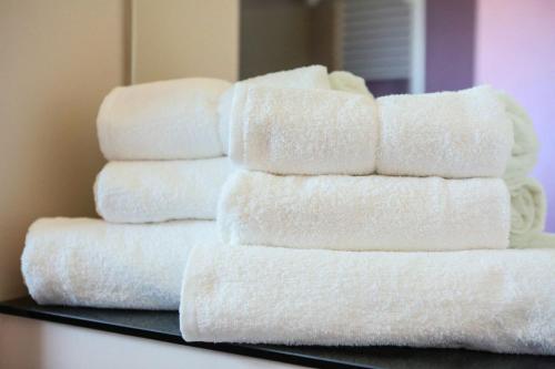 a stack of white towels stacked on a shelf at Sangria Luxury Family in Mamaia Nord