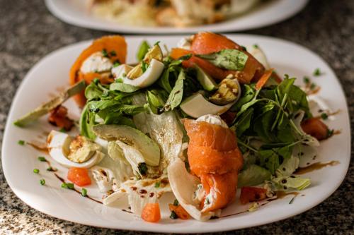 a plate of food with a salad on a table at Senador Dupont- Convento San Francisco & Arboles in Tigre