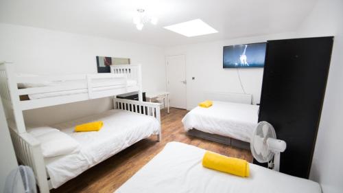 a room with two bunk beds and a table at Rusholme Rooms in Manchester