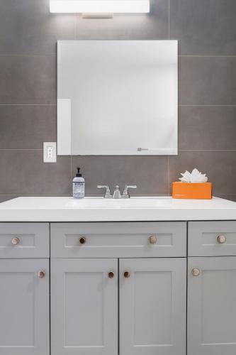 a bathroom with a white sink and a mirror at Prime Yale Location WiFi Wooster Square Parking in New Haven