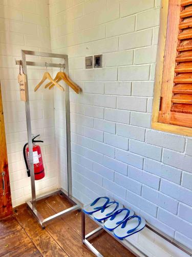 a room with a blue brick wall and a fire hydrant at Eco Wooden Farmhouse in Dieng