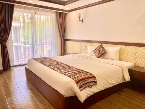 Ένα ή περισσότερα κρεβάτια σε δωμάτιο στο Lechapa Hotel Sapa