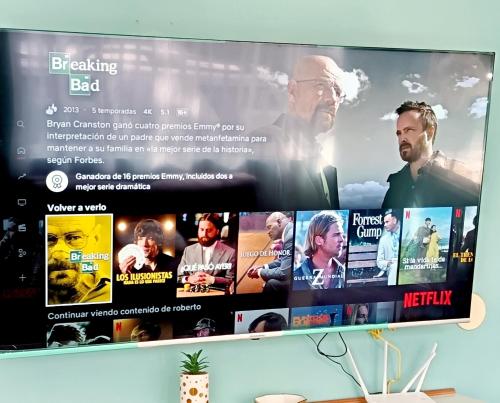 a television screen with a movie on it at Casa bambú con desayuno in Puyo