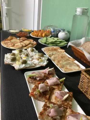 a black table with plates of food on it at B&B Villa Maurizio in Tskaltubo