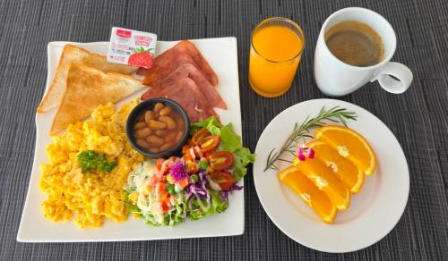 een bord ontbijtproducten met een kopje koffie bij LullaBella Hotel Patong in Patong Beach