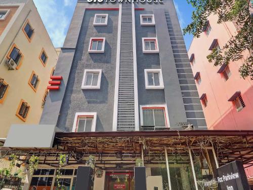 a tall building in the middle of two buildings at Super Townhouse RCC PARK VIEW INN in Hyderabad