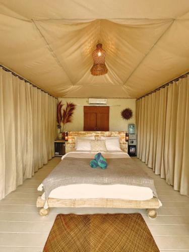 a bedroom with a large bed in a tent at Romantic Eco safary tent,Cozy by Natura,private pool,sea view, Exotic luxury private glamping in Nusa Penida