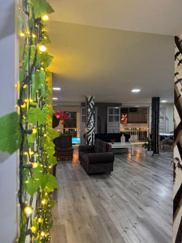 a living room with a couch and a fireplace at HOTEl LAS FLORES in Santa Rosa de Cabal