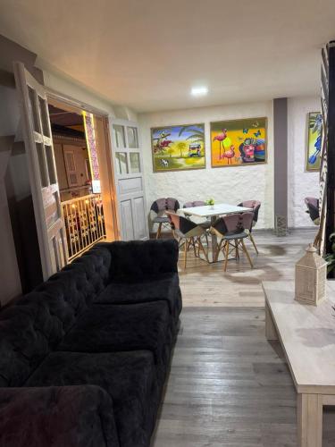 a living room with a couch and a table at HOTEl LAS FLORES in Santa Rosa de Cabal