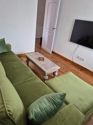 a living room with a couch and a coffee table at The Mountain Links, Upcot, Nuwara Eliya in Maskeliya