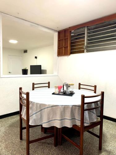 a kitchen with a table with two chairs and a tableablish at Comfort and an excellent area in Venezuela in Maracaibo