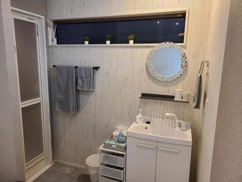 a small bathroom with a sink and a mirror at Greci Art Tokyo-Kinshicho Area Private room- in Tokyo