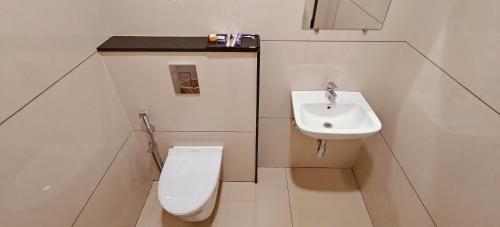 a bathroom with a toilet and a sink at Aswin Residency in Nāmakkal