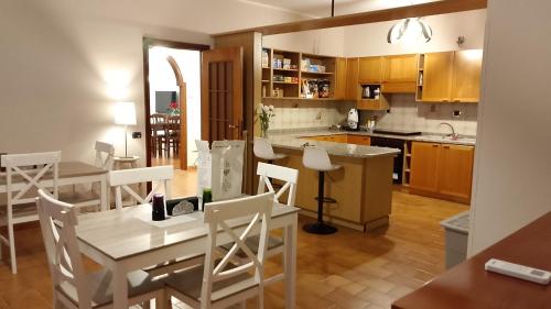 a kitchen and dining room with a table and chairs at House Revolution Style FC in Oliveto Citra