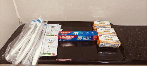 a tray with toothpastes and toothpaste on a table at Aswin Residency in Nāmakkal