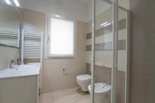 a bathroom with a toilet and a sink and a shower at Residence Armony in Misano Adriatico