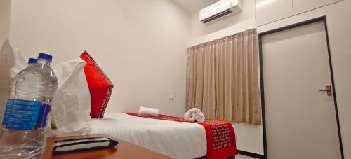 a room with a bed and a bottle of water on a table at Aswin Residency in Nāmakkal