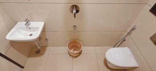 a bathroom with a sink and a toilet at Aswin Residency in Nāmakkal