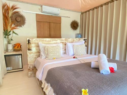 a bedroom with a large bed in a room at Romantic Eco safary tent,Cozy by Natura,private pool,sea view, Exotic luxury private glamping in Nusa Penida