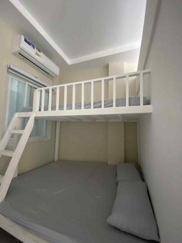 a small room with a bunk bed and a ladder at three x apartelle in Tagbilaran City