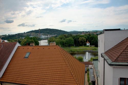 an orange tile roof with a view of a town at Hotel Art in Písek