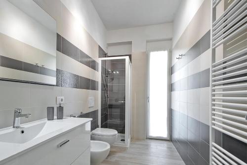 a bathroom with a sink and a toilet and a shower at Residence Armony in Misano Adriatico