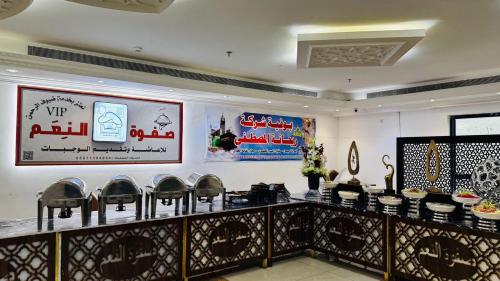 a restaurant with chairs and posters on the wall at فندق اركان بكة in Al Khansāk