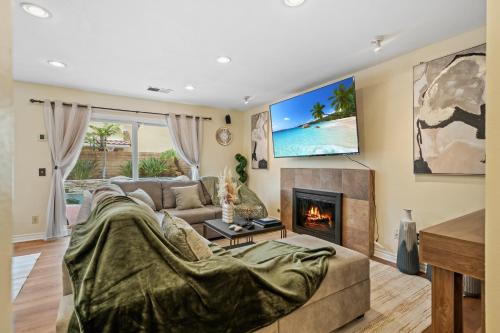 a living room with a couch and a fireplace at Entire Private 4-BR w Pool, Hot Tub, King Bed, Garage, Available Now in El Cajon