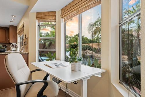 a kitchen with a white table and a window at Entire Private 4-BR w Pool, Hot Tub, King Bed, Garage, Available Now in El Cajon