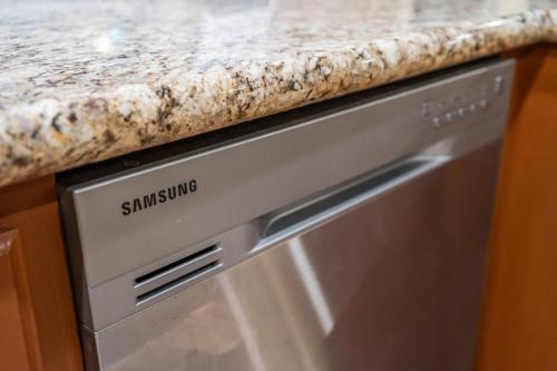 a granite counter top on top of a dishwasher at Entire Private 4-BR w Pool, Hot Tub, King Bed, Garage, Available Now in El Cajon