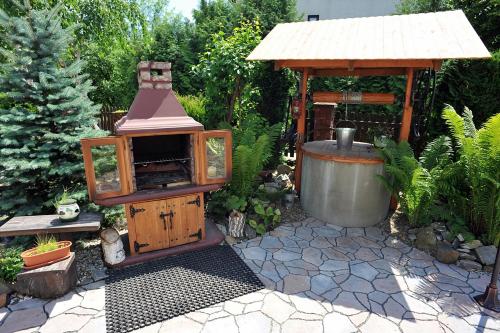 a garden with a wood stove and a gazebo at Dom U Kuby in Hoczew
