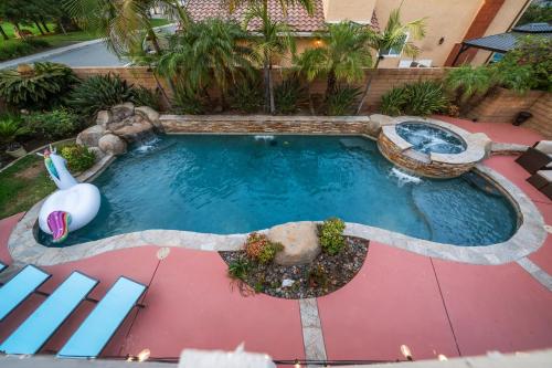 an overhead view of a pool with a water slide at Entire Private 4-BR w Pool, Hot Tub, King Bed, Garage, Available Now in El Cajon
