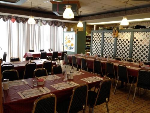 a conference room with tables and chairs in a room at KC's Country Inn in Vars