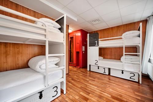 a room with three bunk beds in it at Generator Stockholm in Stockholm