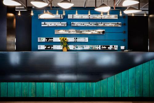 a black counter with flowers on a blue wall at Generator Stockholm in Stockholm