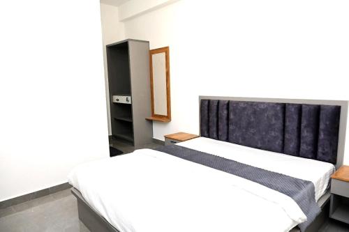 a bedroom with two beds and a mirror at The REEF LOUNGE in Mandya