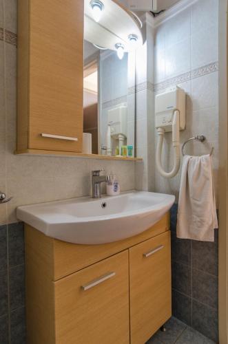 a bathroom with a sink and a mirror at Plaka Studios in Karfas