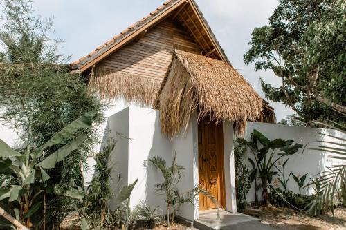 a small house with a thatched roof at Romantic private villas Bayrin private villas in Nusa Penida