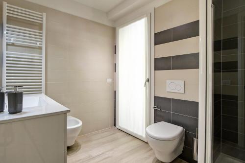 a bathroom with a toilet and a sink at Residence Armony in Misano Adriatico