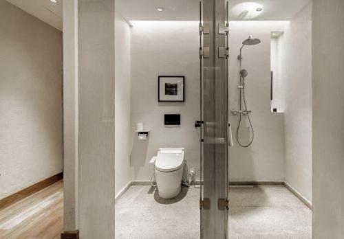 a bathroom with a toilet and a shower at Ancient Charm Inn Chengdu in Chengdu