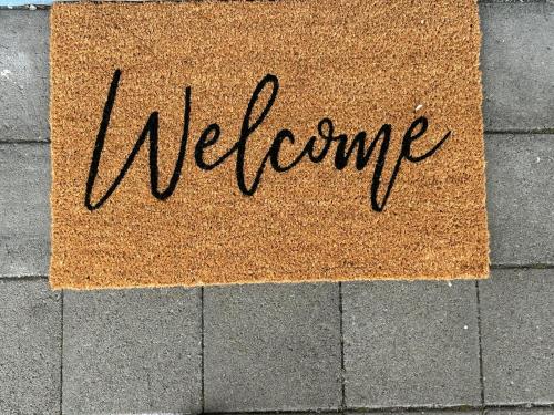 a welcome sign on the side of a wall at Mollymook Ocean View Motel Rewards Longer Stays -over 18s Only in Mollymook