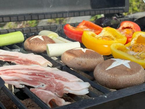 a grill with meat and vegetables on it at TAKUMI-AN Private Ancient House and Garden in Numazu