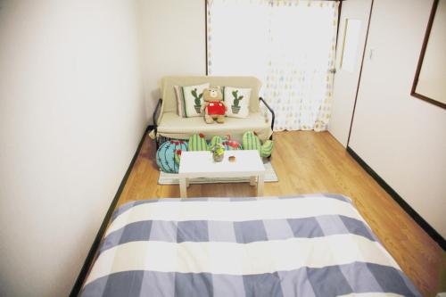 a small room with a chair and a table at Sweet House東池袋 in Tokyo