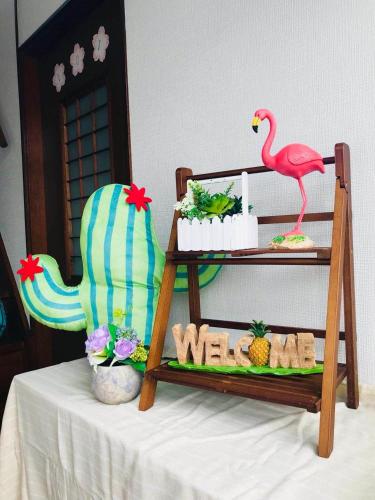 a table with a shelf with a flamingo and some food at Sweet House東池袋 in Tokyo