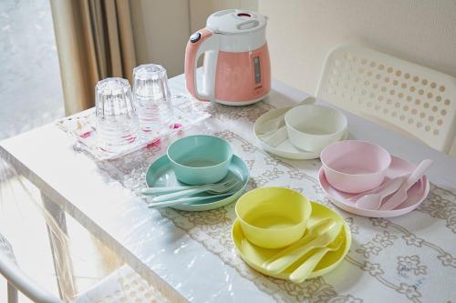 a table with plates and cups and a tea pot at Sweet House東池袋 in Tokyo