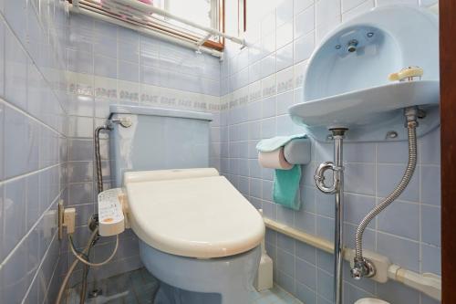 a bathroom with a toilet and a sink at Sweet House東池袋 in Tokyo