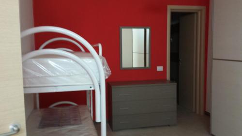 a red room with a bunk bed and a mirror at Villa Malandrino Guest House in Agropoli