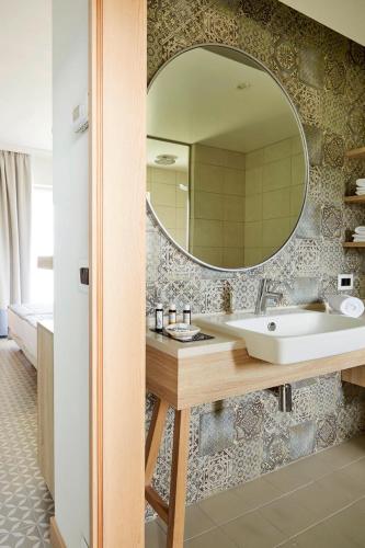 a bathroom with a sink and a mirror at ROBINSON KYLLINI BEACH - All Inclusive in Kyllini